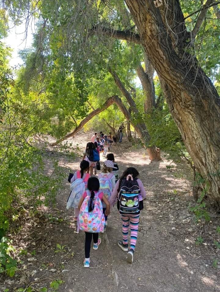 children with backpacks on a hike